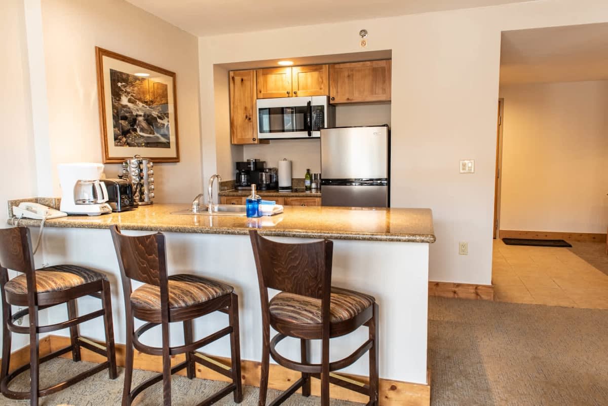 Kitchen with bar top | Listed with @BookTraverse