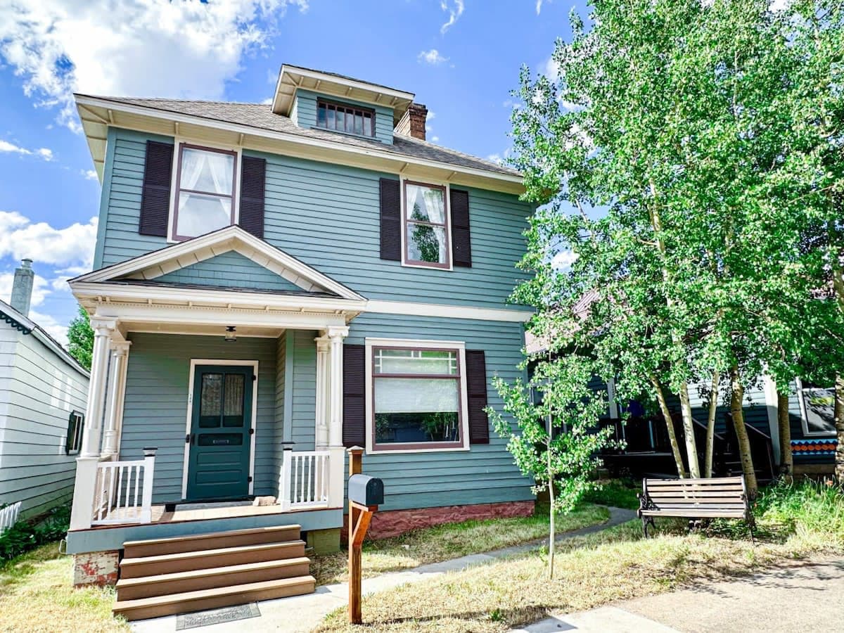 【Exterior — Summer】 1880s Victorian on E 8th — one block from Harrison Ave, wildflower season June through August.