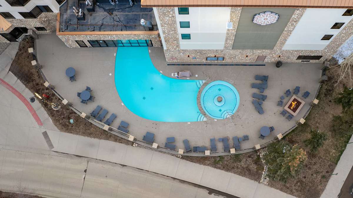 【Pool Deck】Lounge chairs and the hot tub — same complex, different view