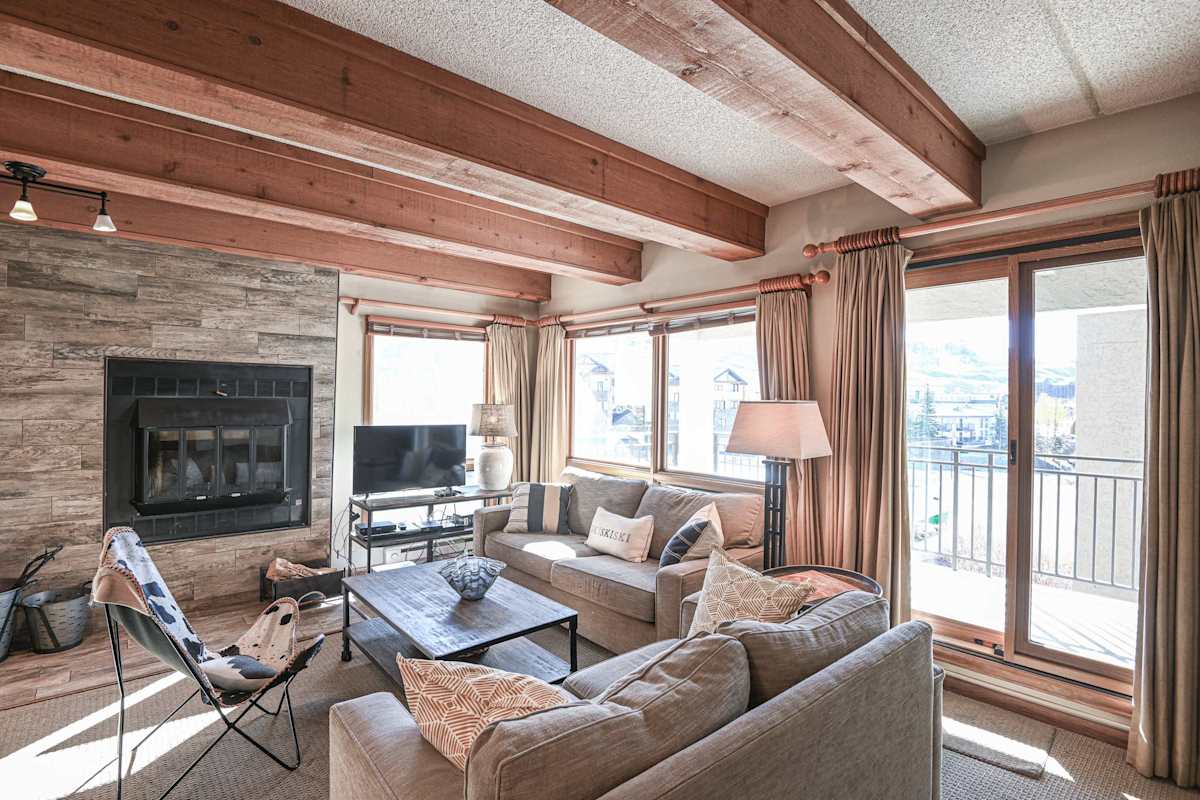 【Fireplace + View】Stone wood fireplace + mountain window + hammock chair — après-ski warmth