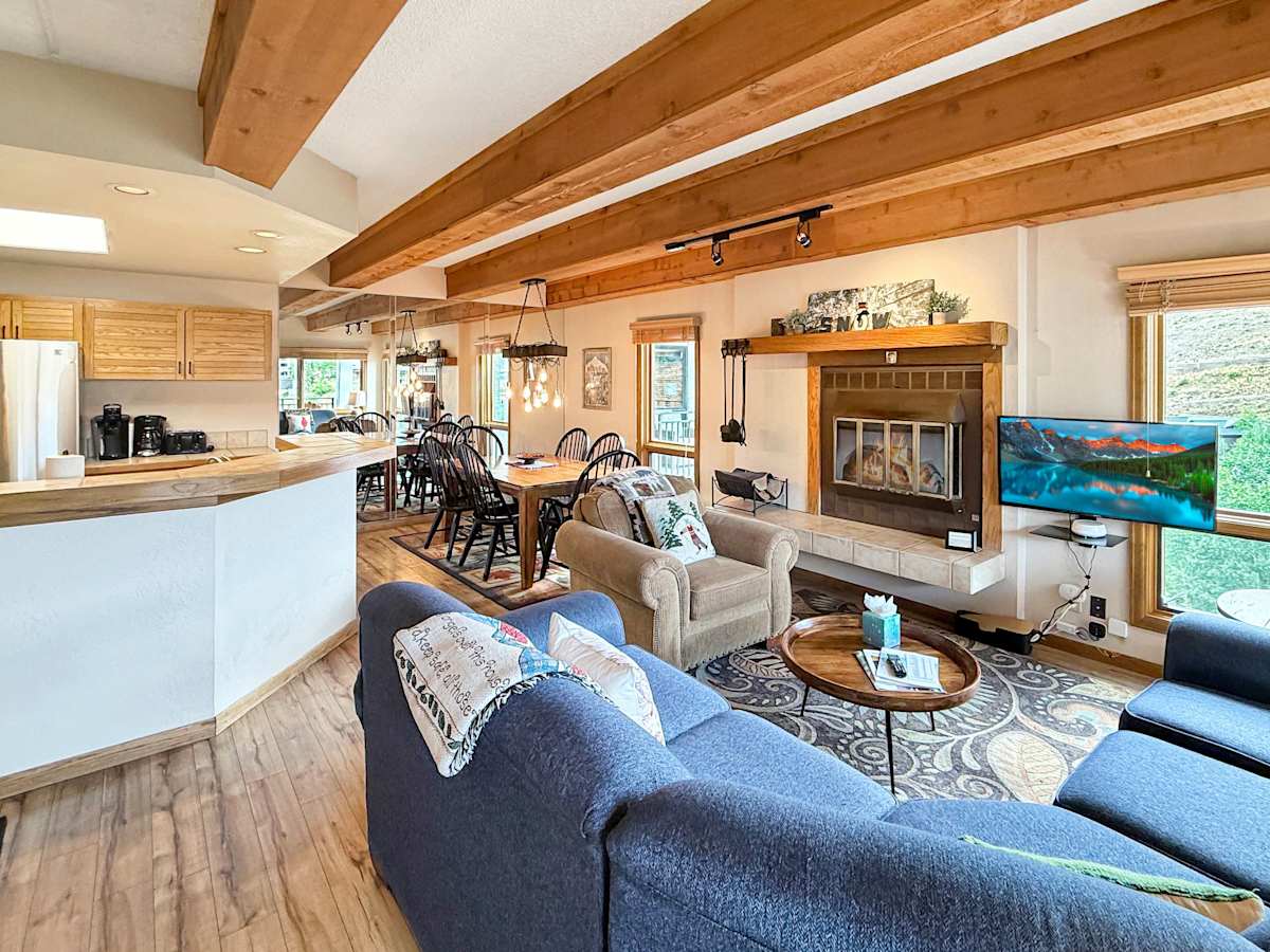 Open Concept living and diding with Wood burning fireplace and smart tvs | Listed with @BookTraverse