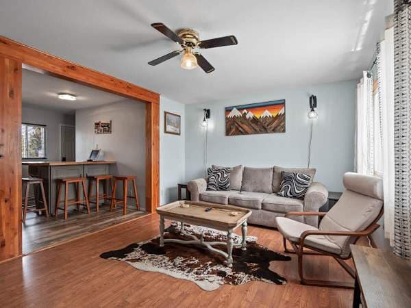【Living Room】Brick accent wall and a sectional — the main-floor hangout
