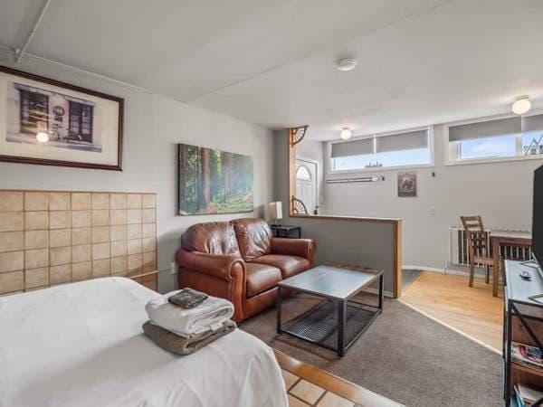 a queen bed and a living area