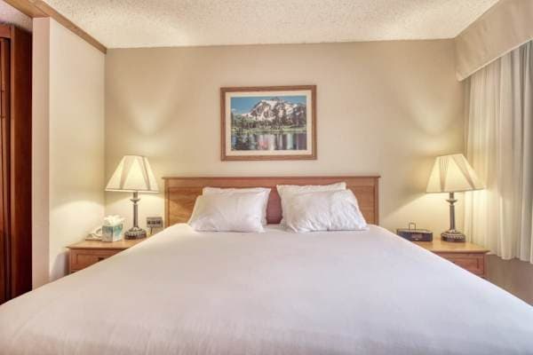 【King Bed】Room-darkening shades behind the curtains let you sleep in after a powder day.