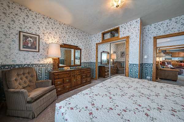 【Bedroom 1 — King】 Sitting corner — adults get the quiet end of the house.