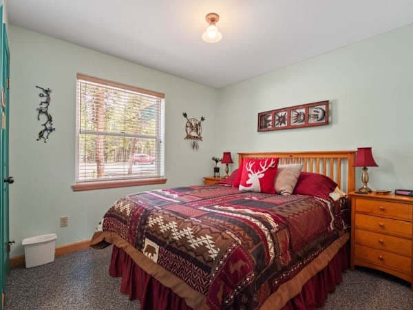 【Main-floor Bedroom — alt angle】Looking back from the doorway — full vanity light and door to the main bath.