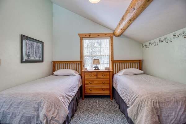 【Loft】Two twin beds tucked under pitched beams — kids claim it first, every time.
