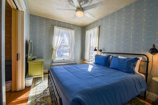 【King Bedroom】 King iron bed, period wallpaper, radiator heat — blackout curtains for deep sleep at 10,152 ft.