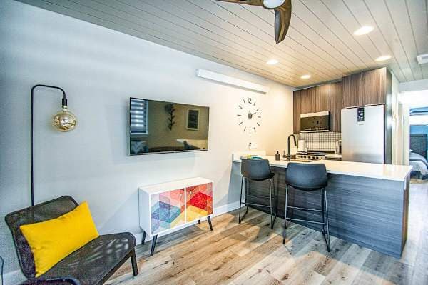 【Kitchen + Dining】Open-plan layout — cook at the range, eat at the counter or patio table, one flowing space.