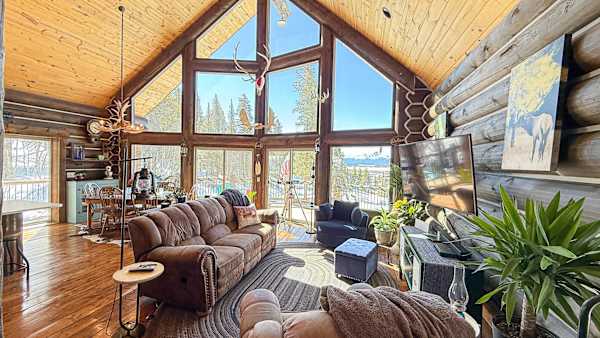 【Living Room】 Couch and chairs angle at the view through the A-frame's triangular wall of glass