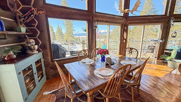 【Dining Area】 Farmhouse table seats 6 in front of the south-facing windows — sunrise coffee, sunset dinner