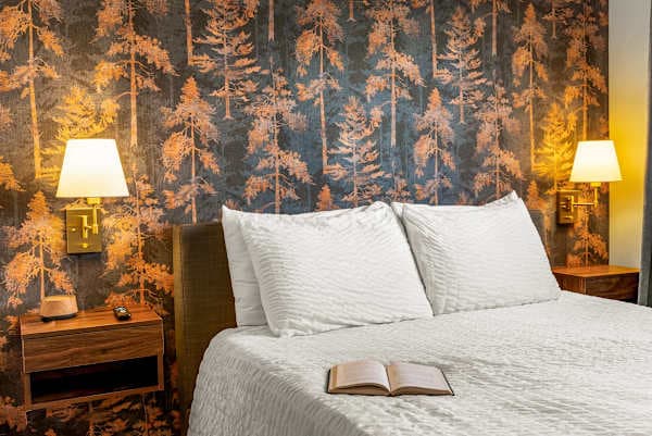 【Bedrooms】 3 queen beds, each with mountain views — forest wallpaper in BR1 sets the mood