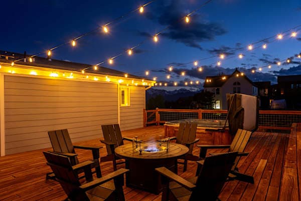 【Deck at Dusk】 String lights come on at sunset — the hot tub is already warm