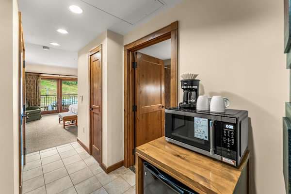 Mini Fridge, Microwave and Coffee Maker for convenience. | Listed with @BookTraverse