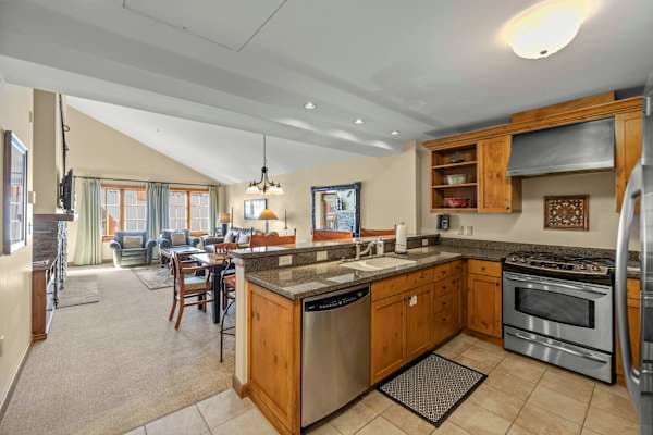 Well Stocked open kitchen with bar seating | Listed with @BookTraverse