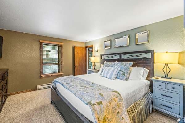 【Bedroom 1 — Primary King】King bed + en-suite bath — quiet end of the condo