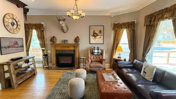 Main Living Room: Original 1893 fireplace, 12-ft ceilings -- seat the whole group