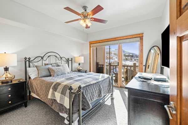 【Primary Bedroom】Queen bed + ensuite bath + private balcony opening to the Mt. Crested Butte view