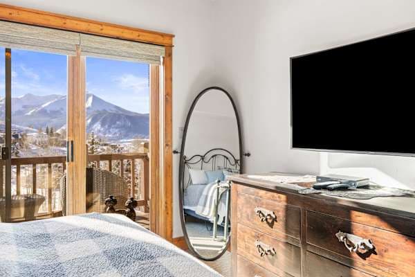 【Primary Bedroom】Wide angle — wall TV and mountain light through the window