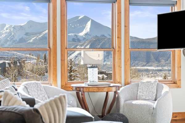 【Great Room View】Mt. Crested Butte framed by vaulted windows — morning coffee seat