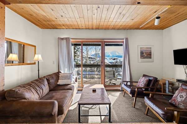Living room with balcony and Mountain Views Pull out sofa | Listed with @BookTraverse