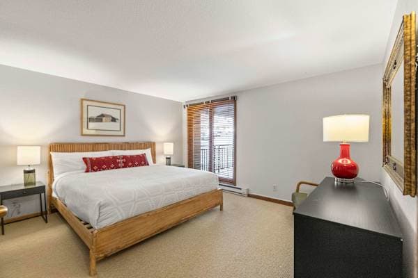 【Bedroom 1】 King bed — the master, with full bath and storage just behind the door.