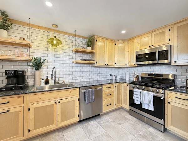 【Kitchen Detail】 Subway tile, butcher-block shelving, gas range — built for actual cooking