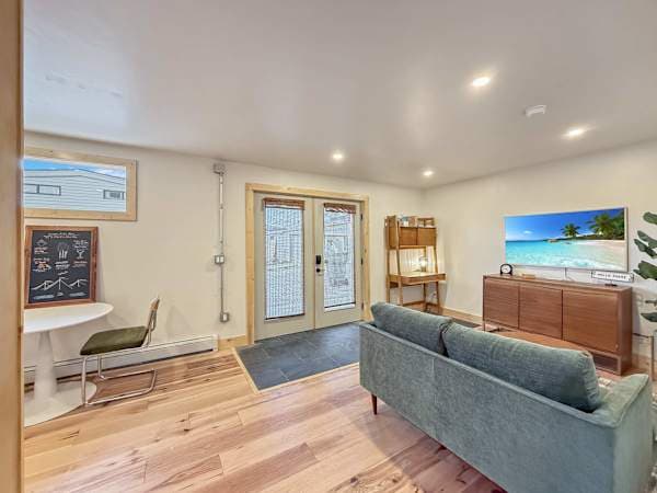 【Living Room】 Green velvet sofa + French-door entry — slate tile inside, hardwood out